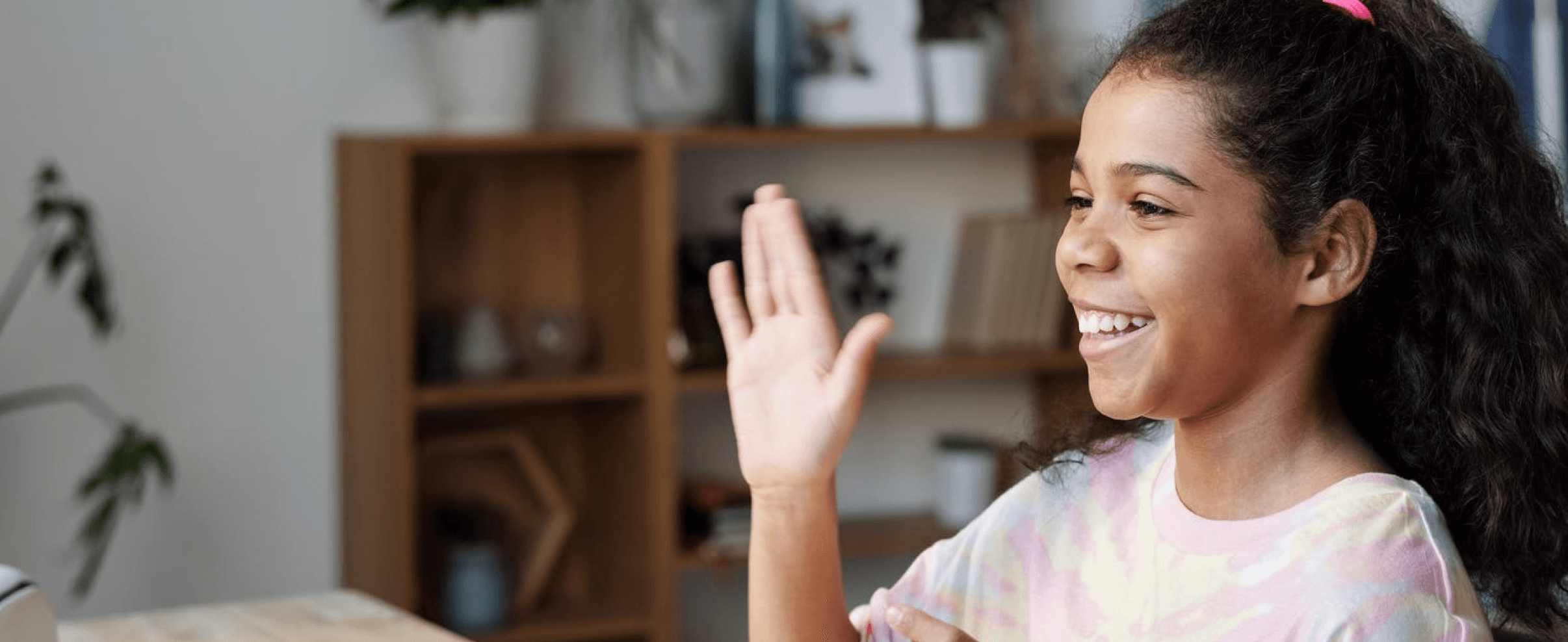 Spelling Bee of Canada Image of female child waving at computer screen