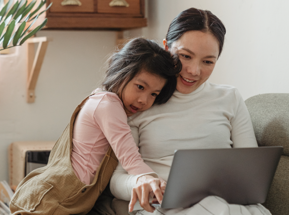 Child and parent looking at laptop screen