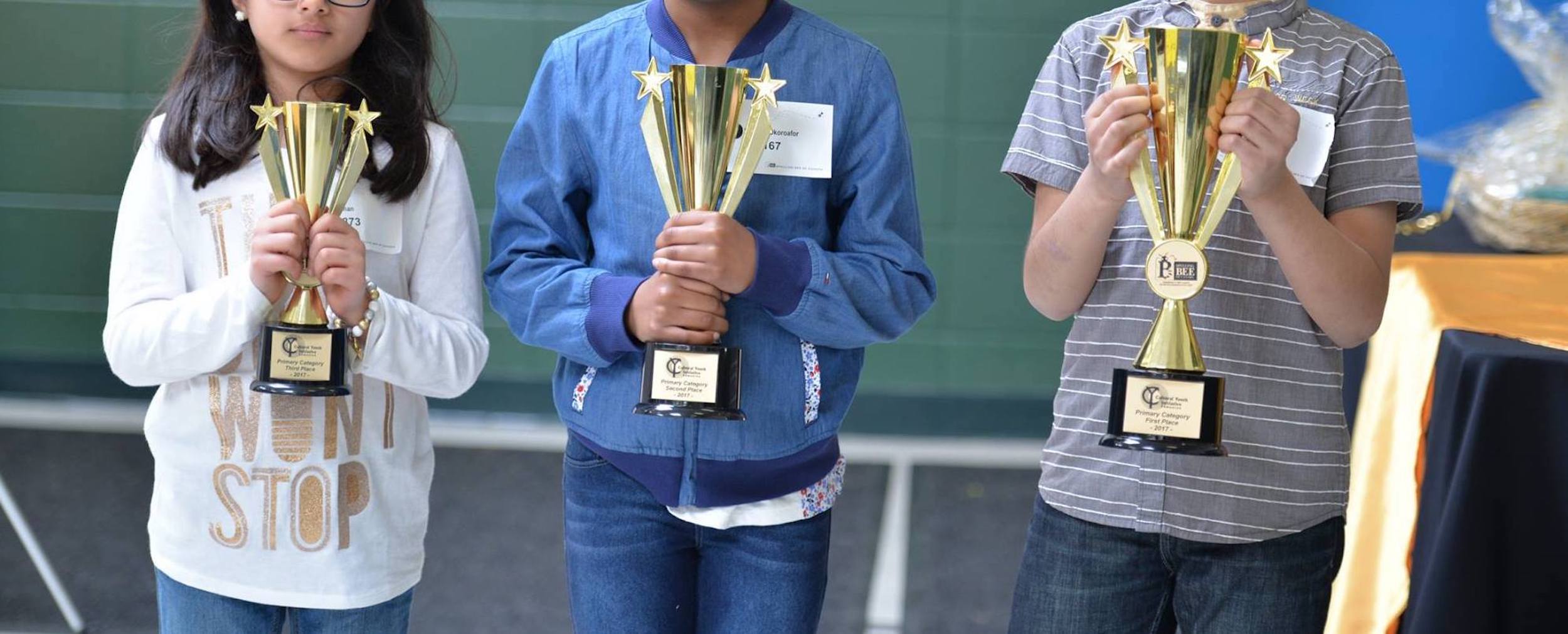 Kids holding trophies